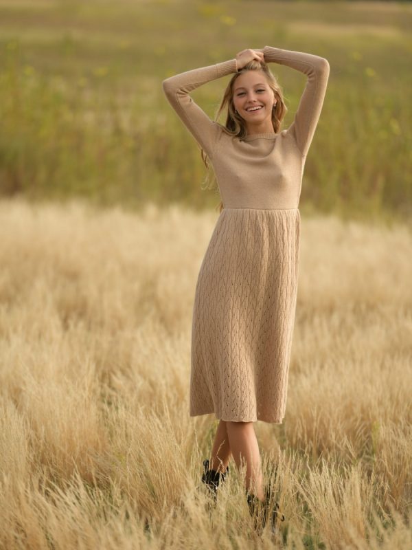 Cream long knitted casual dress with a relaxed fit, featuring a V-neckline, long sleeves, and ribbed detailing. Perfect for a cozy yet stylish look