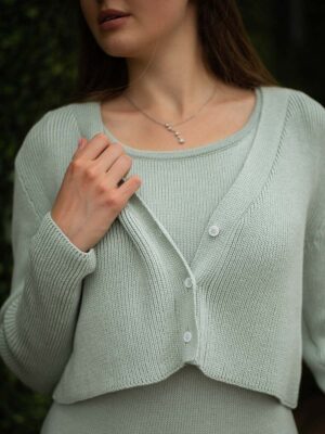 A stylish cropped mint jacket made by Pasma Design, featuring a collarless neckline, long sleeves, and a unique textured fabric. Perfect for adding a pop of color to any outfit.